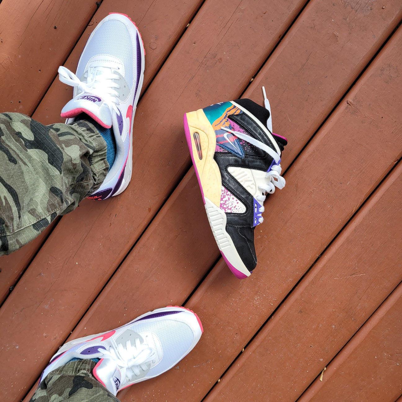 Overhead shot of a man wearing camp pants, airn max 90 sneakers and a vintage nike sneaker on the floor infront of his feet