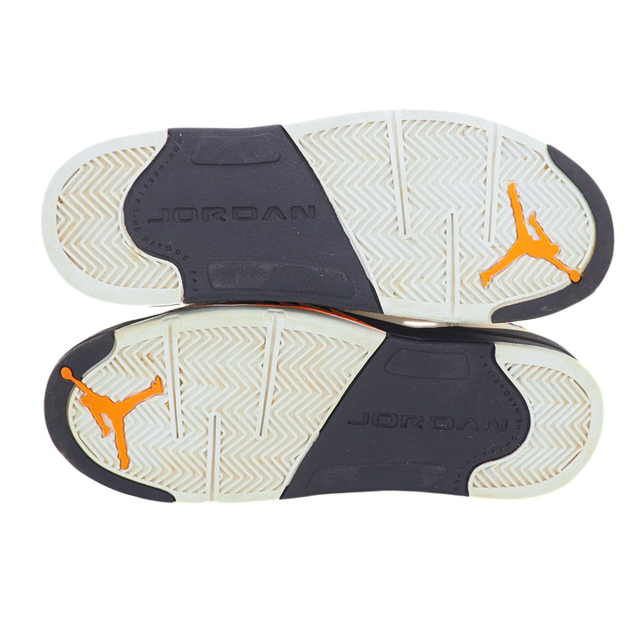 Close-up of Jordan brand shoe soles with orange logo on a white background