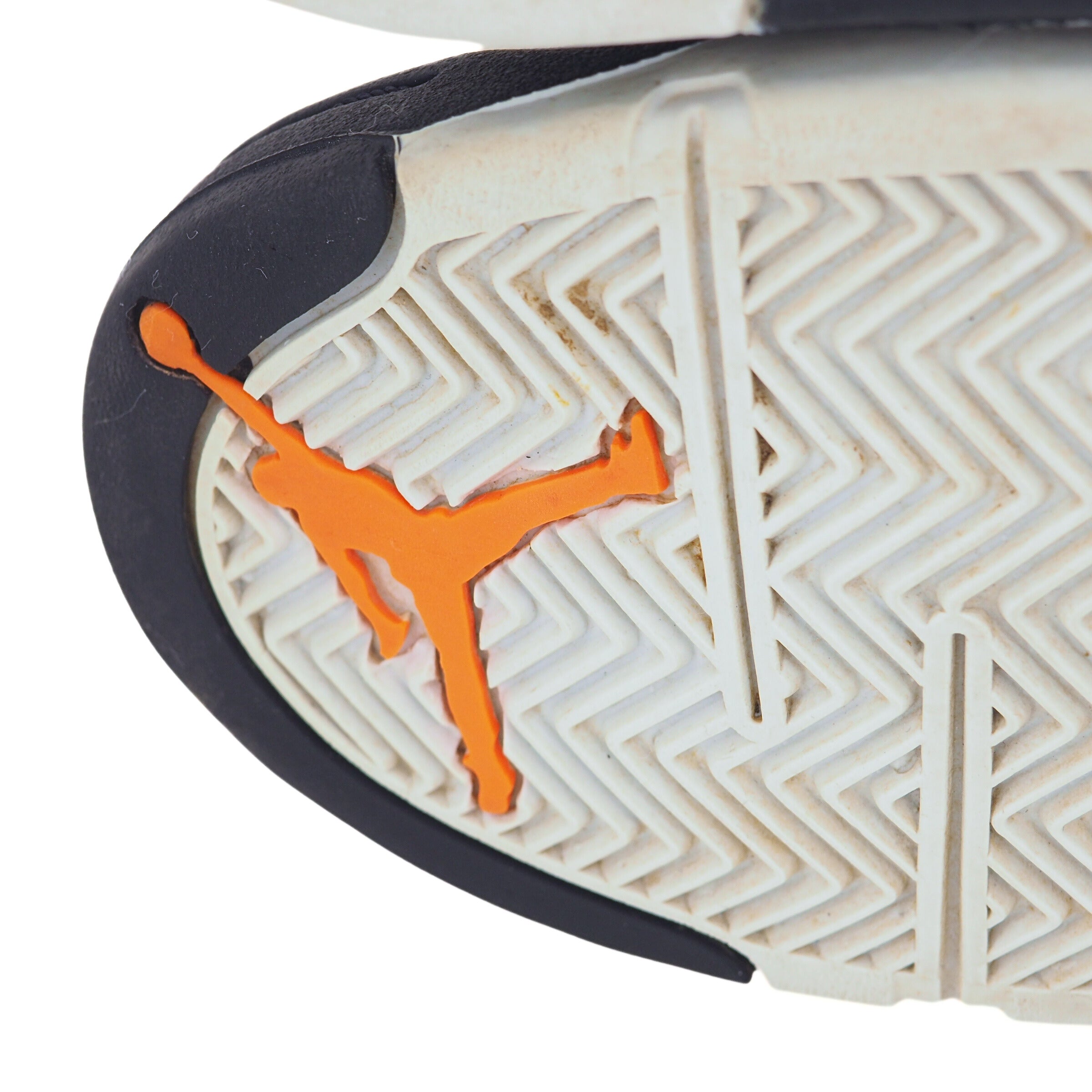 Close-up of a sneaker sole with an orange Jordan Jumpman logo on a white background