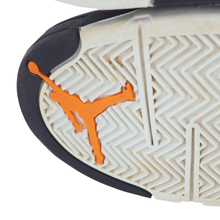 Close-up of a sneaker sole with an orange Jordan Jumpman logo on a white background