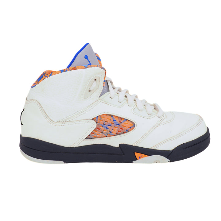 White Jordan 5 sneaker with orange and blue accents on a white background