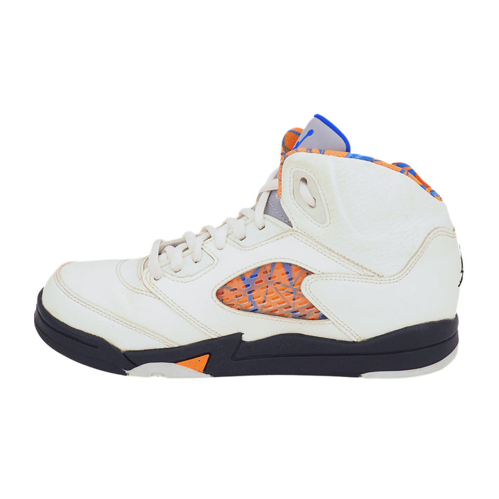 White Jordan sneaker with orange and blue accents on a white background