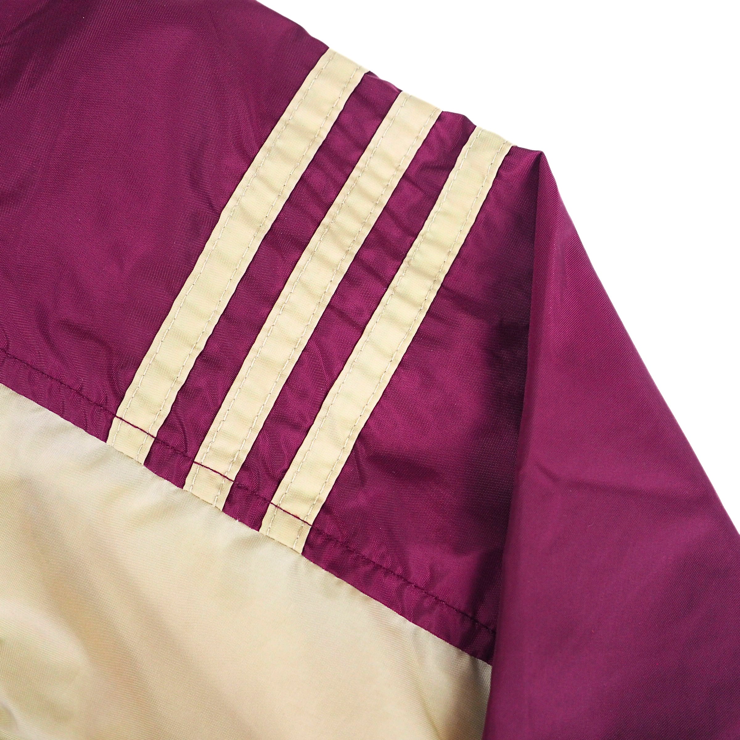 Adidas three stripes on the shoulder of a vintage anorak jacket in gold and burgundy