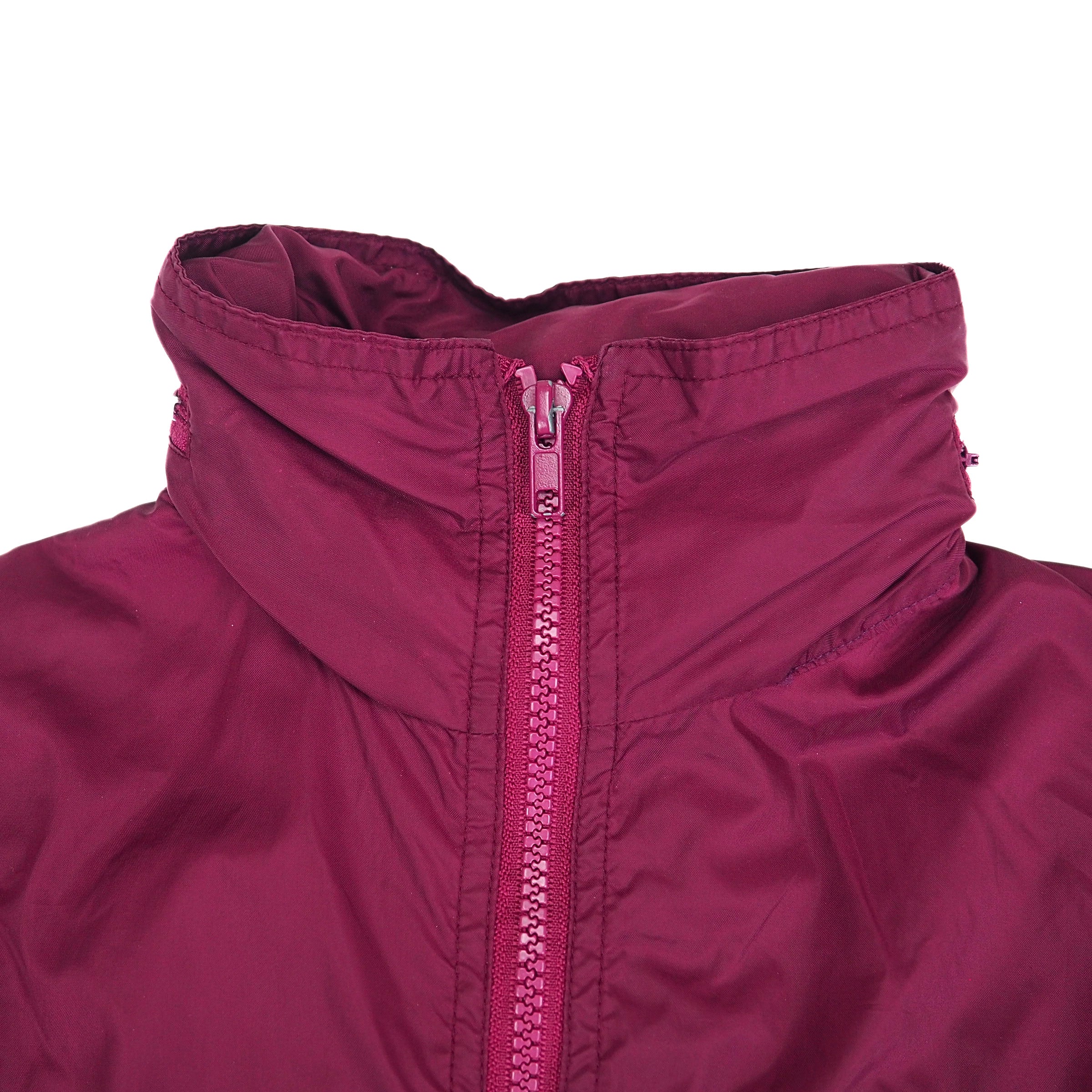 Close-up of a burgundy jacket collar with a zipper on a white background