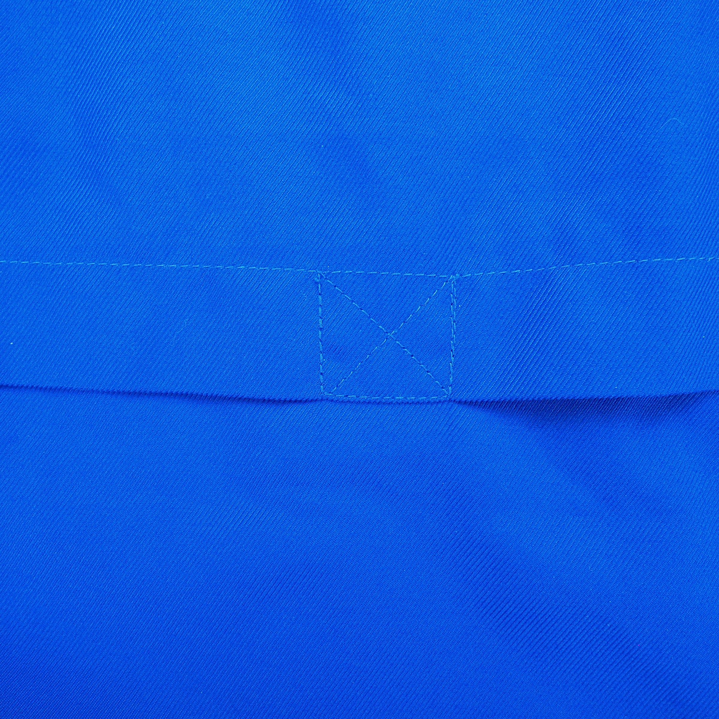Close up of stitching detail on a blue jacket
