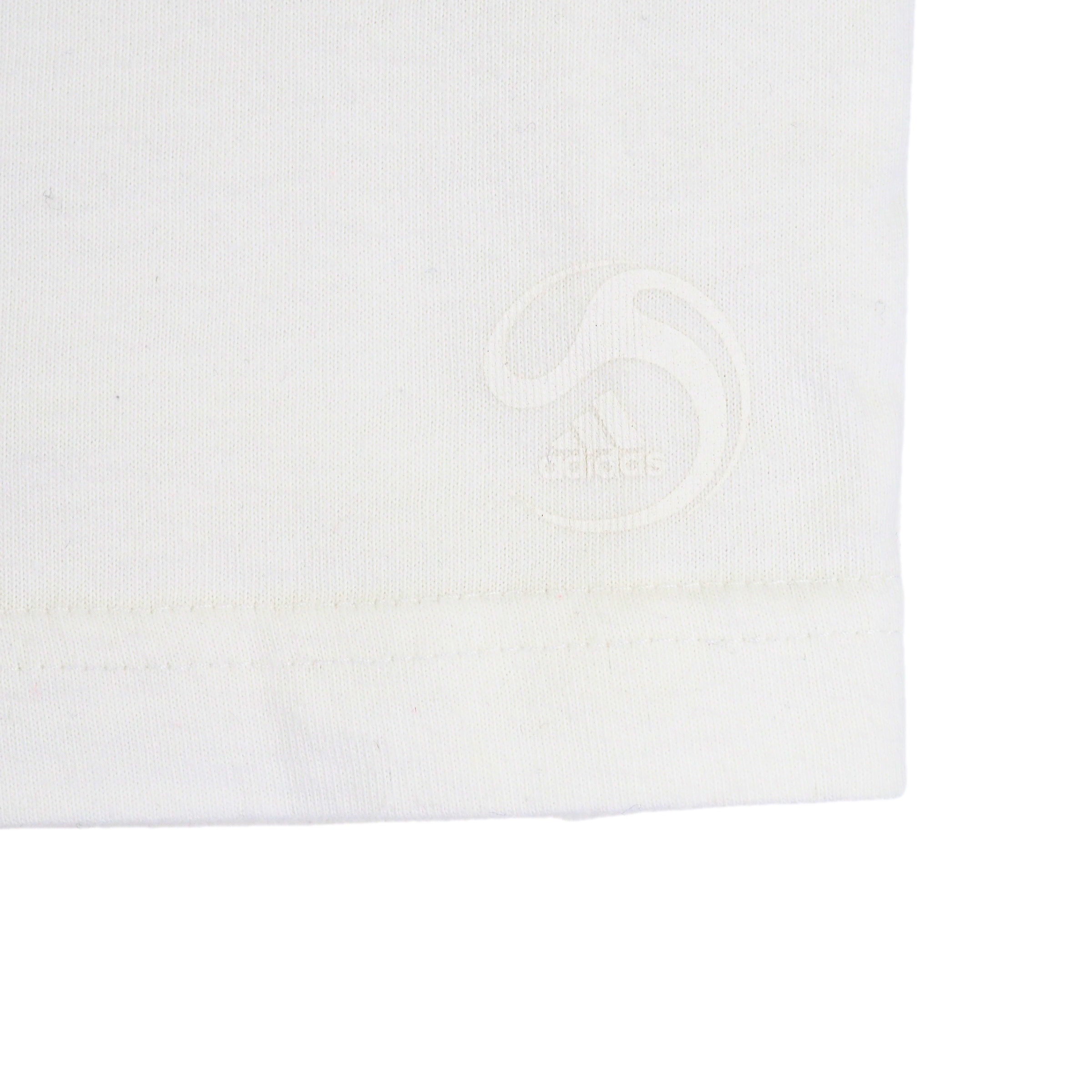 Close up of the hem of a t-shirt with a subtle white adidas soccer logo