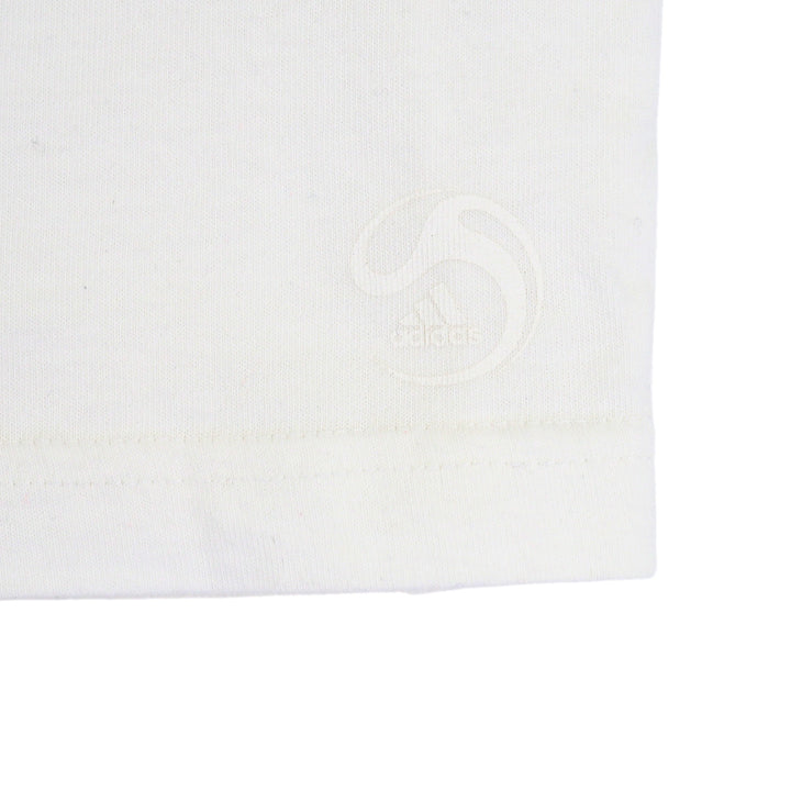 Close up of the hem of a t-shirt with a subtle white adidas soccer logo
