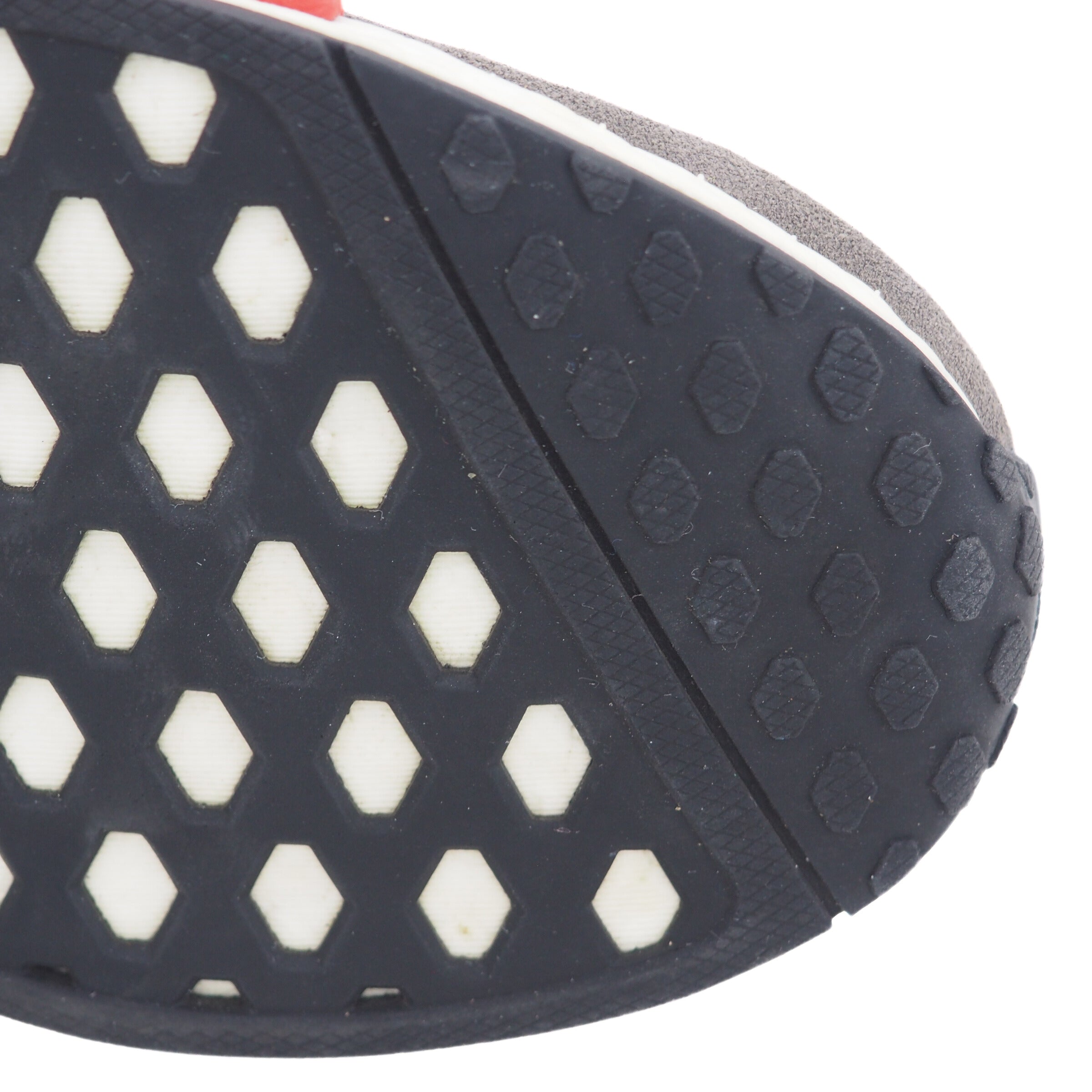 Close-up of a shoe sole with hexagonal pattern and tread design.