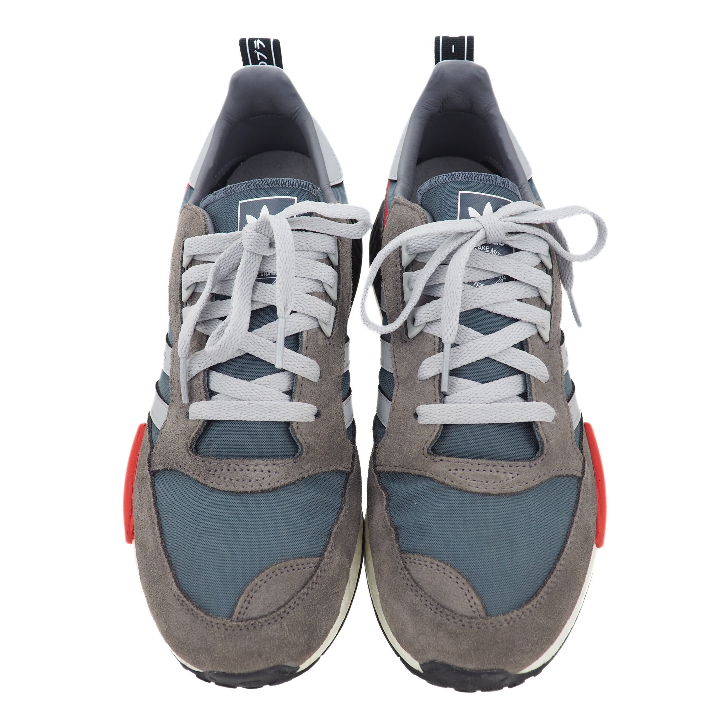 Pair of gray and blue adidas sneakers with light gray laces on a white background