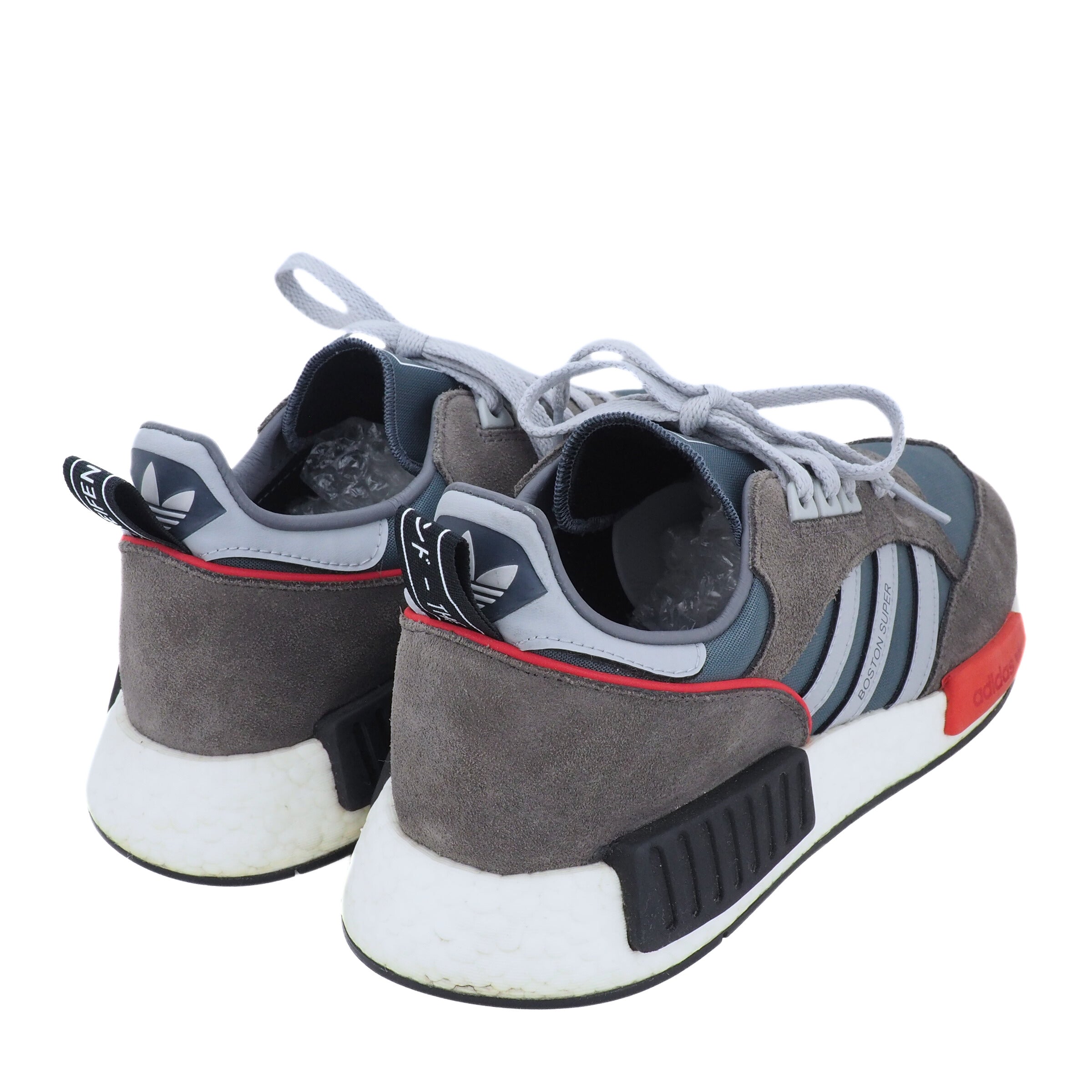 Gray and black Adidas sneakers with white soles on a white background