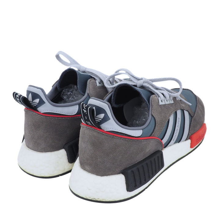 Gray and black Adidas sneakers with white soles on a white background