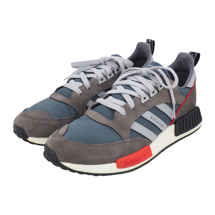 Gray and blue adidas sneakers with gray laces and red accents on a white background