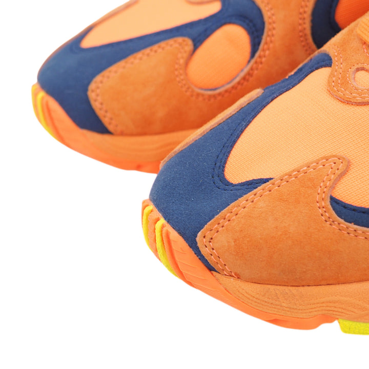 Close up of the toe area of a pair of Orange and blue athletic shoes on a white background