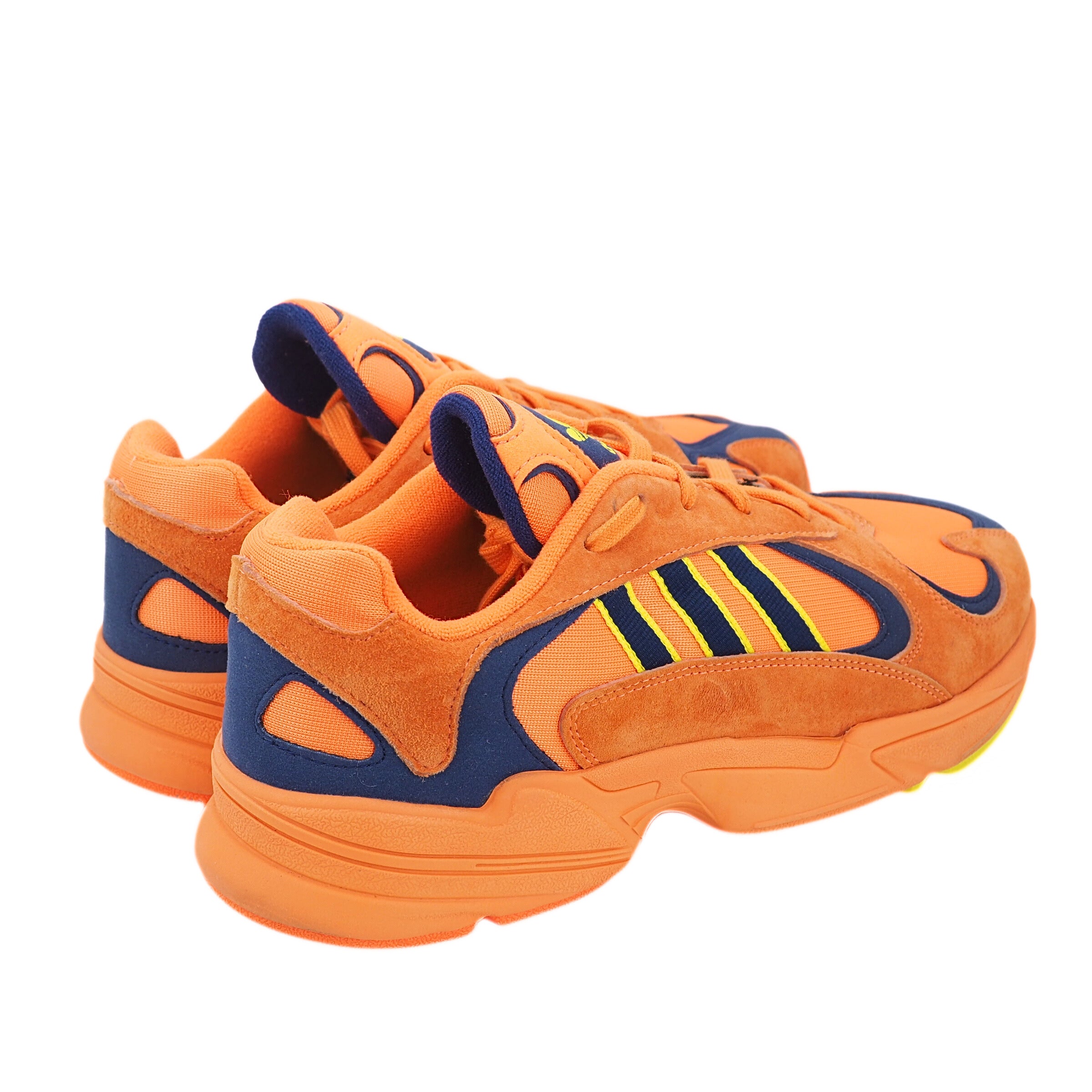 Orange and blue adidas sneakers with a brand logo on a white background