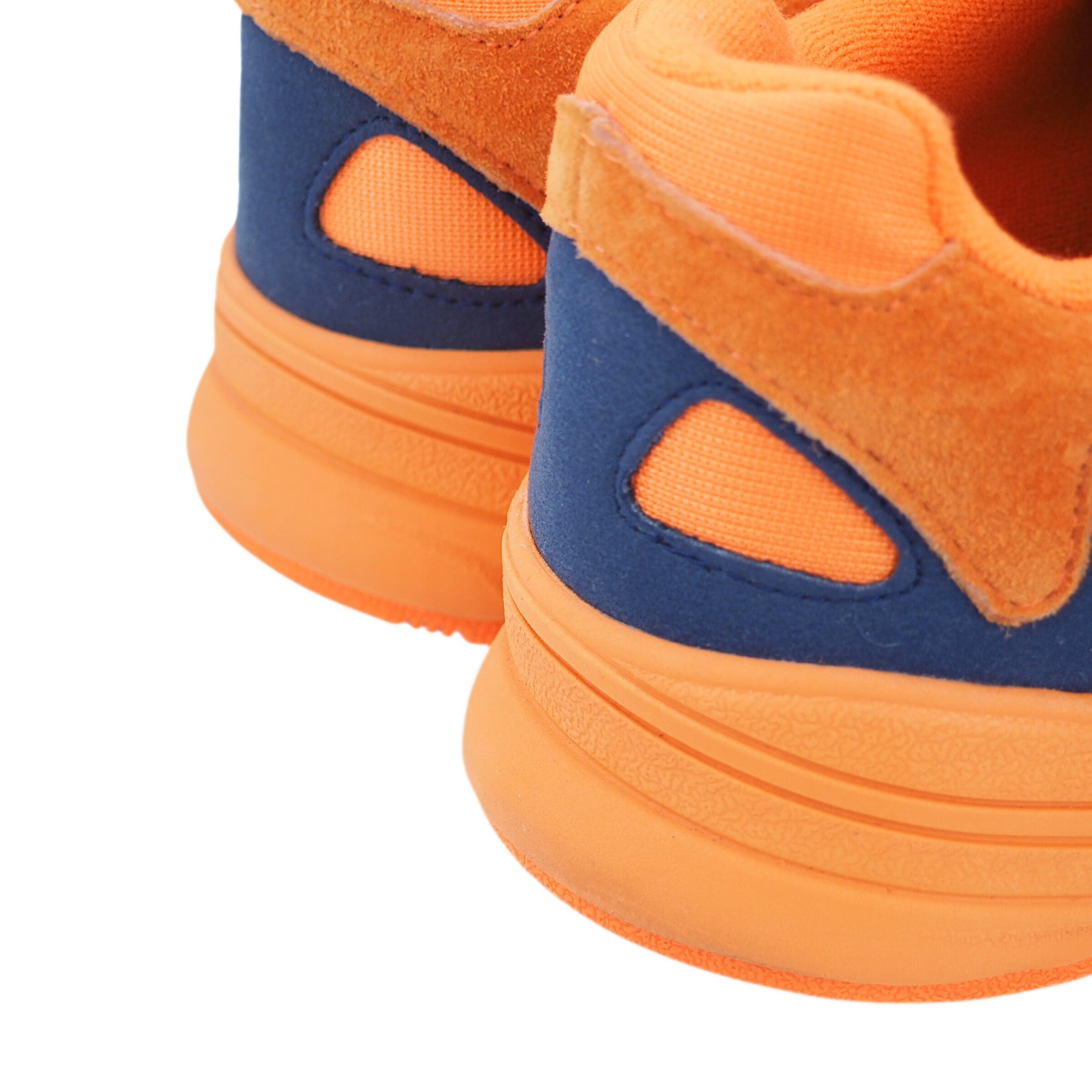 Close-up of the heel of a pair of orange and blue shoes on a white background