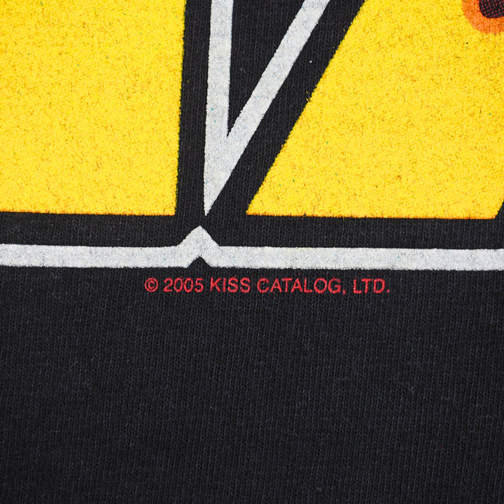 Close up of a black t-shirt graphic logo with subtext that reads 'Copyright 2005 Kiss Catalog td.'