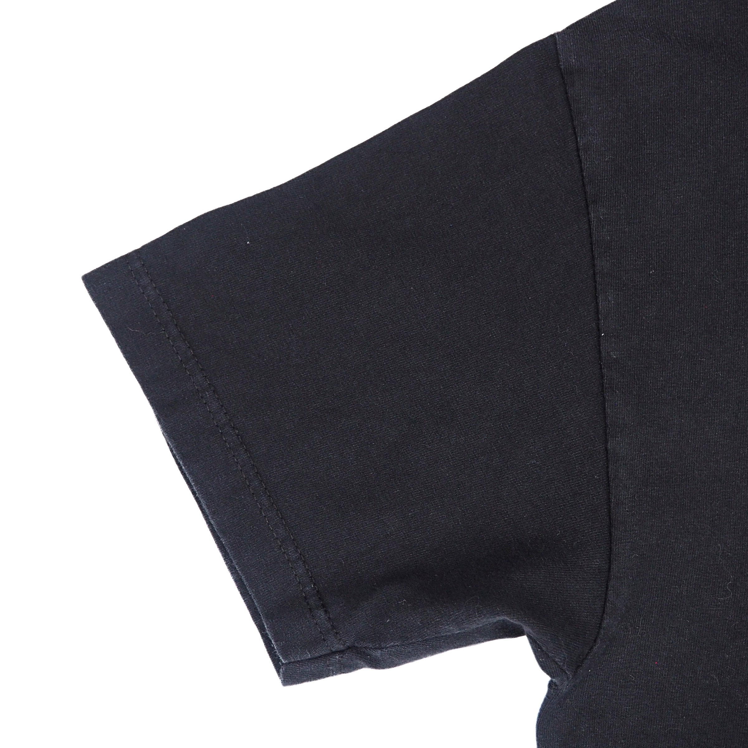 Close up of the sleeve of a black short sleeved t-shirt on a white background