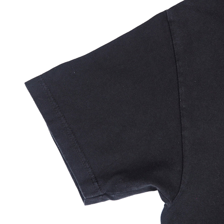 Close up of the sleeve of a black short sleeved t-shirt on a white background