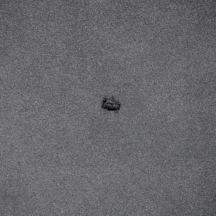Detail of a hole in a piece of black cotton fabric