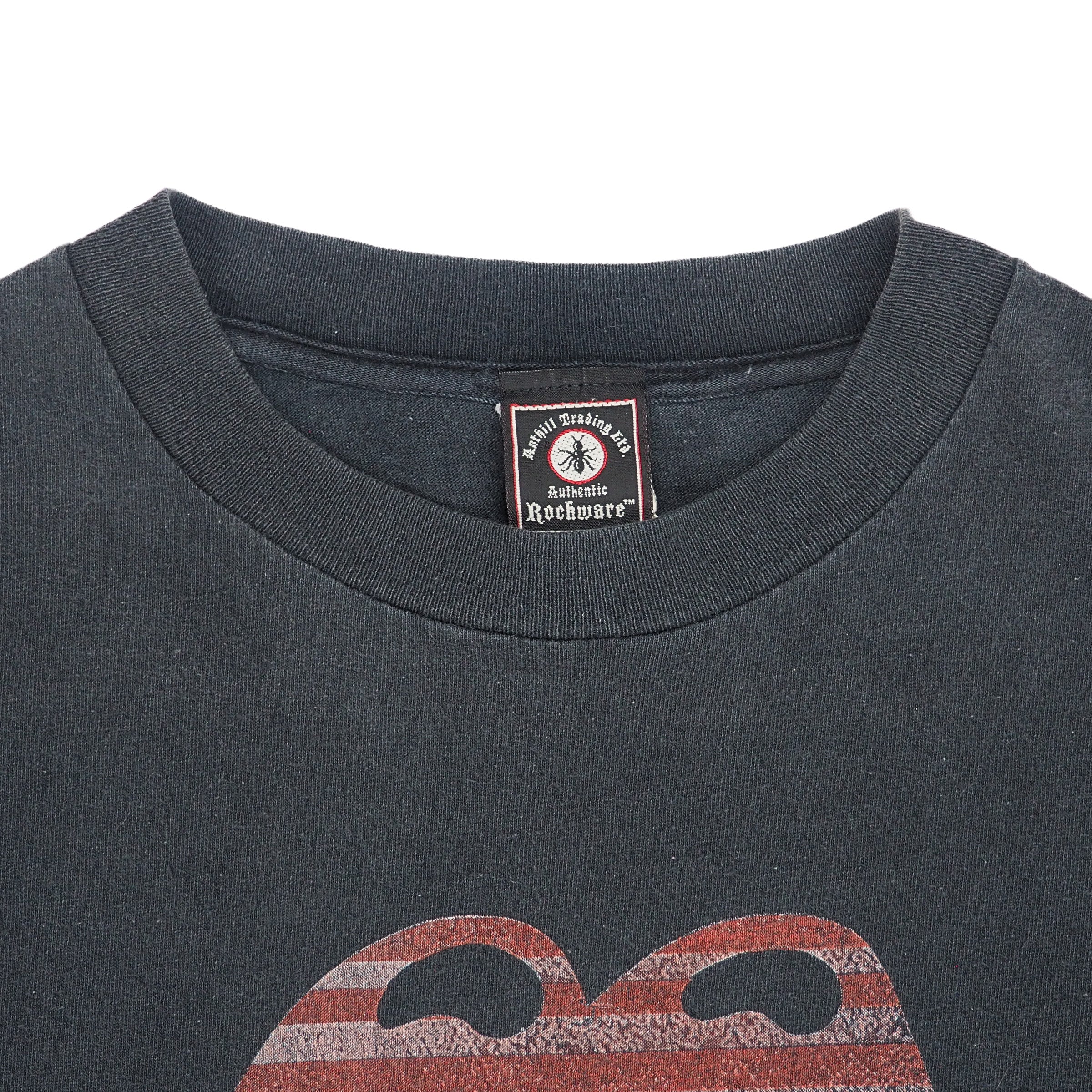 Close up of the collar of a faded black vintage t-shirt with brand label on a white background