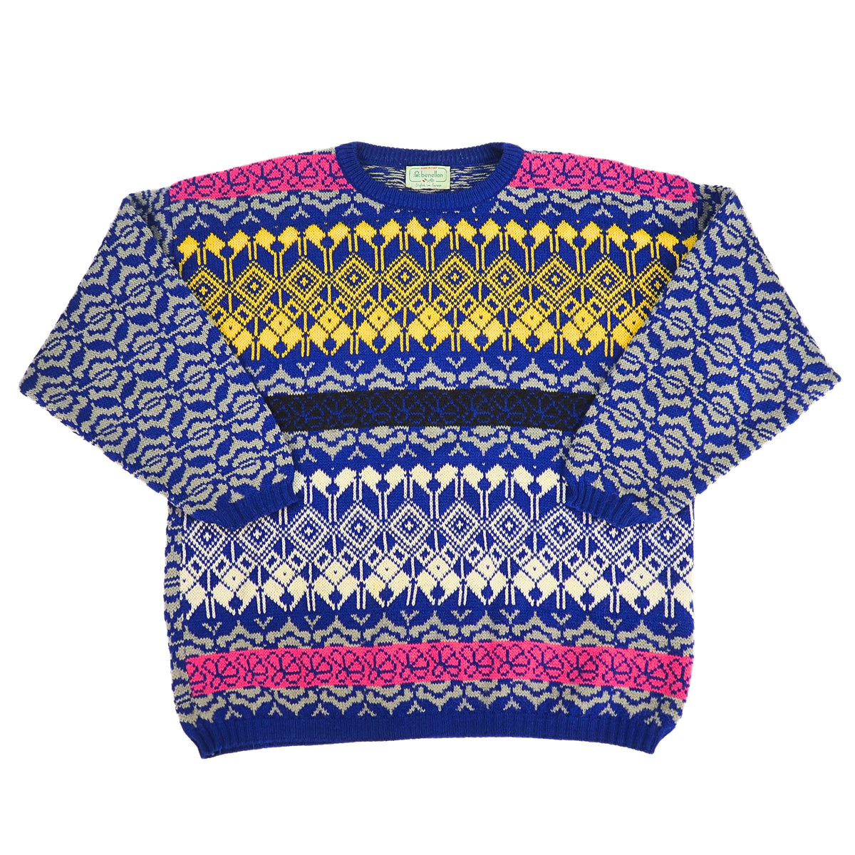 A multicolor knit crewneck sweater with a complex geometric and tribal pattern. The base color is royal blue, decorated with yellow, cream, and hot pink patterned bands across the chest and shoulders, set against a plain white background.