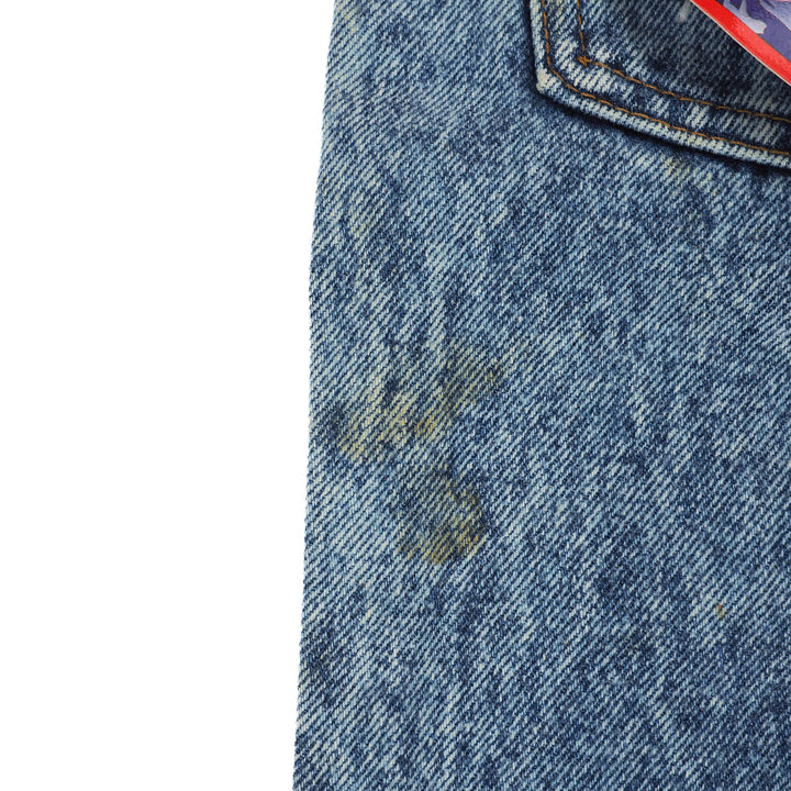Close-up of a blue denim fabric with a stain on a white background
