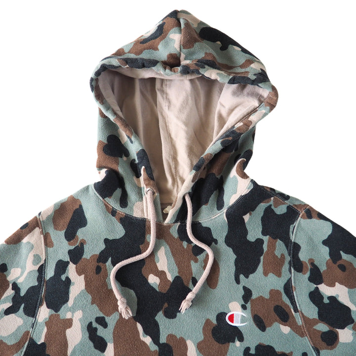Camouflage hoodie with drawstrings and a Champion 'C' brand logo on a white background