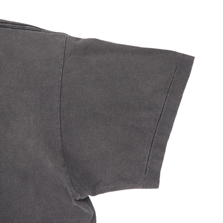Close-up detail of a dark gray short-sleeve t-shirt sleeve with a clean hem and shoulder seam, set against a plain white background.