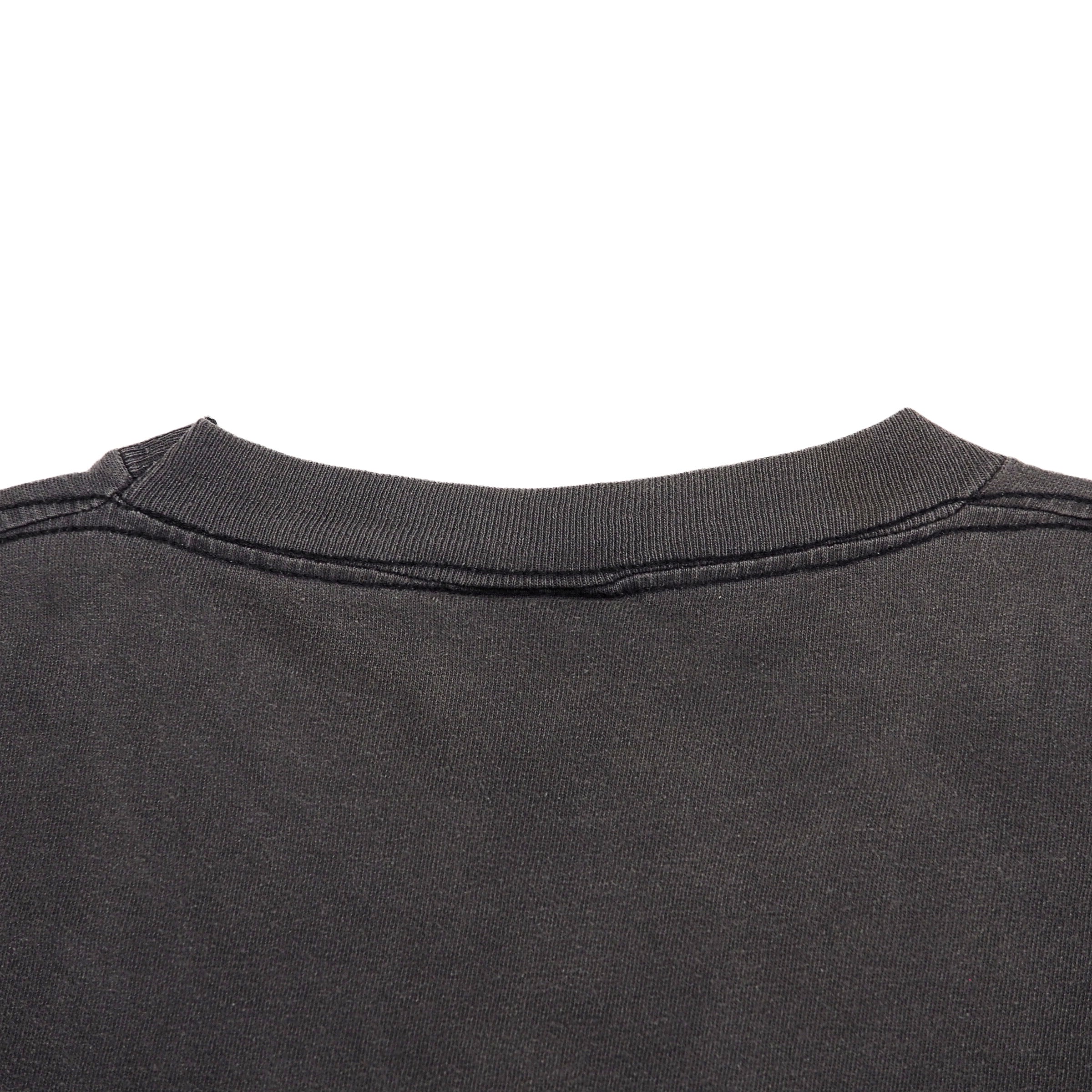 Close-up of the back collar of a dark charcoal gray t-shirt on a solid white background.