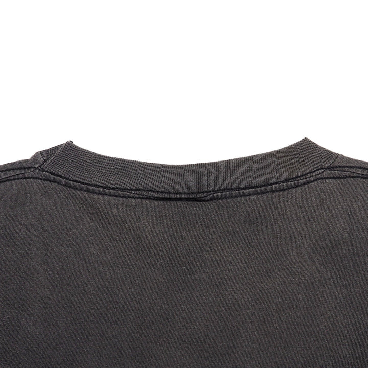 Close-up of the back collar of a dark charcoal gray t-shirt on a solid white background.