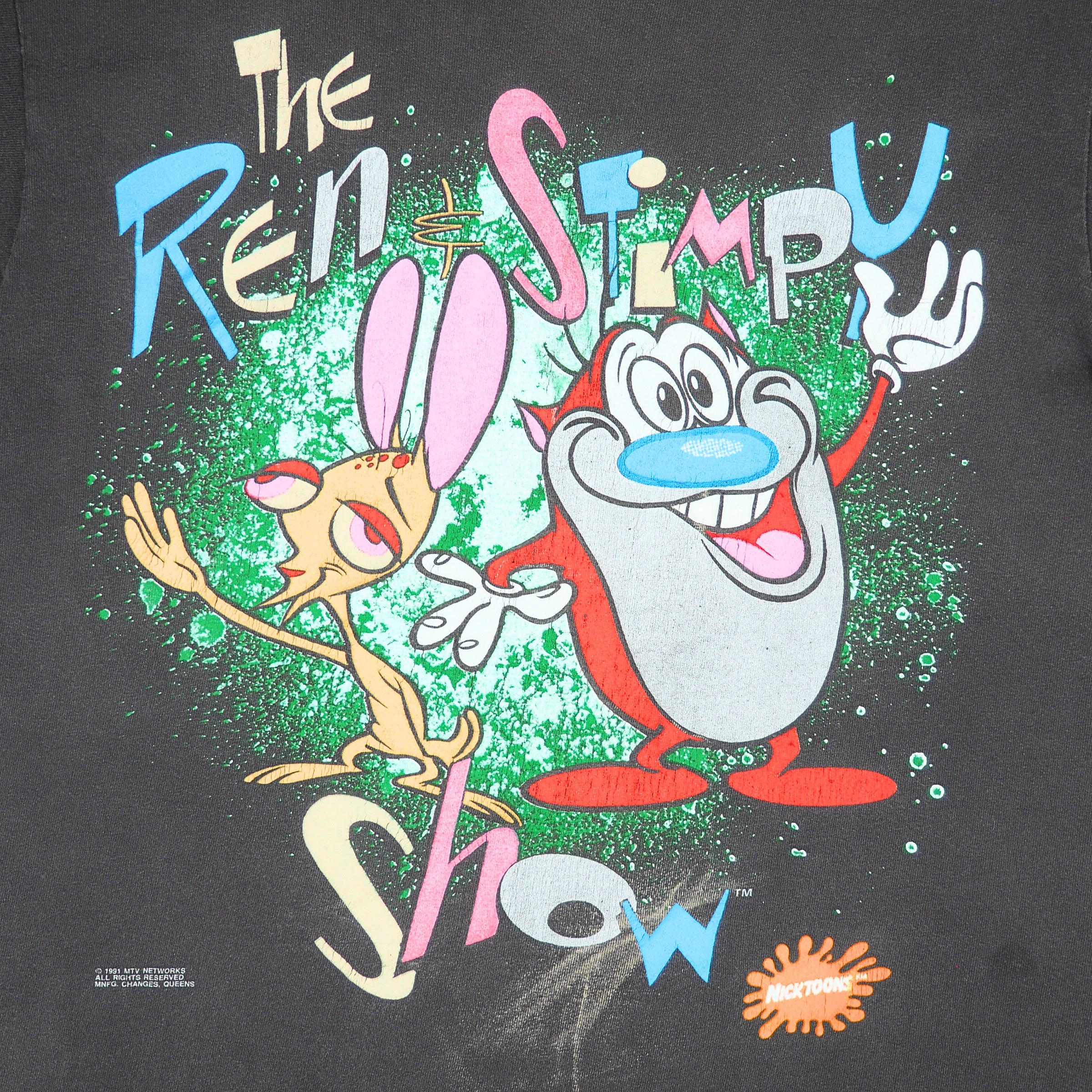 A close-up of a black graphic T-shirt featuring the cartoon characters Ren and Stimpy with the words 'The Ren Stimpy Show' in colorful lettering.