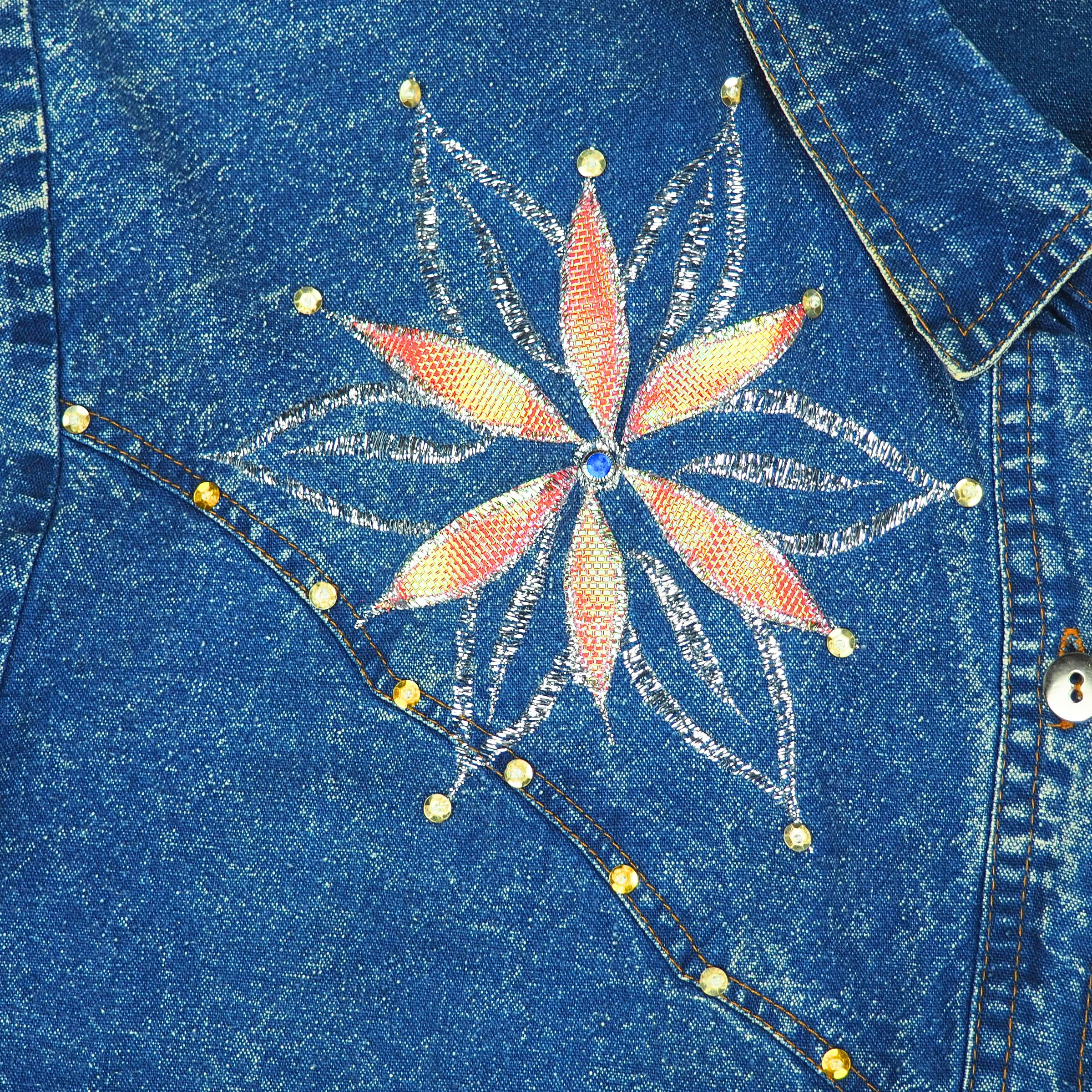 Blue denim shirt with a colorful embroidered and beaded flower design