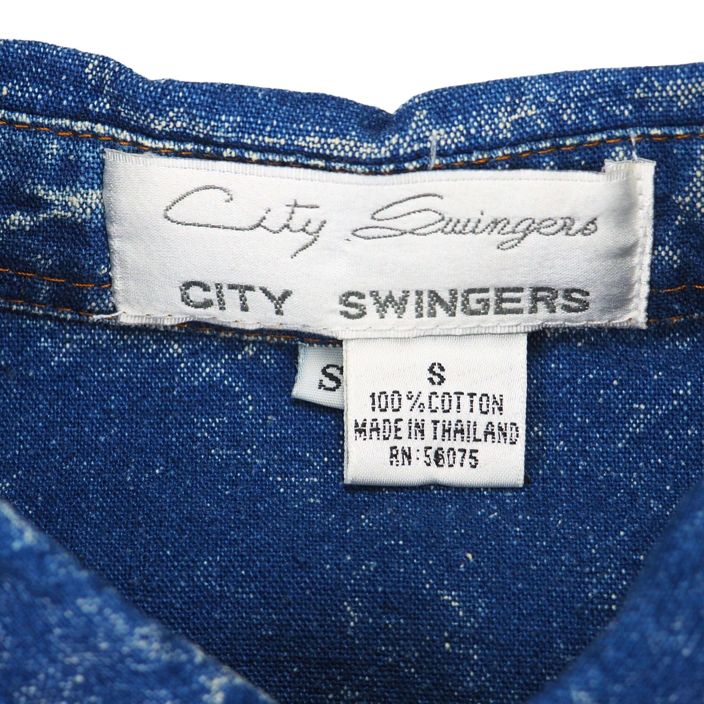 Close-up of City Swingers label on denim fabric