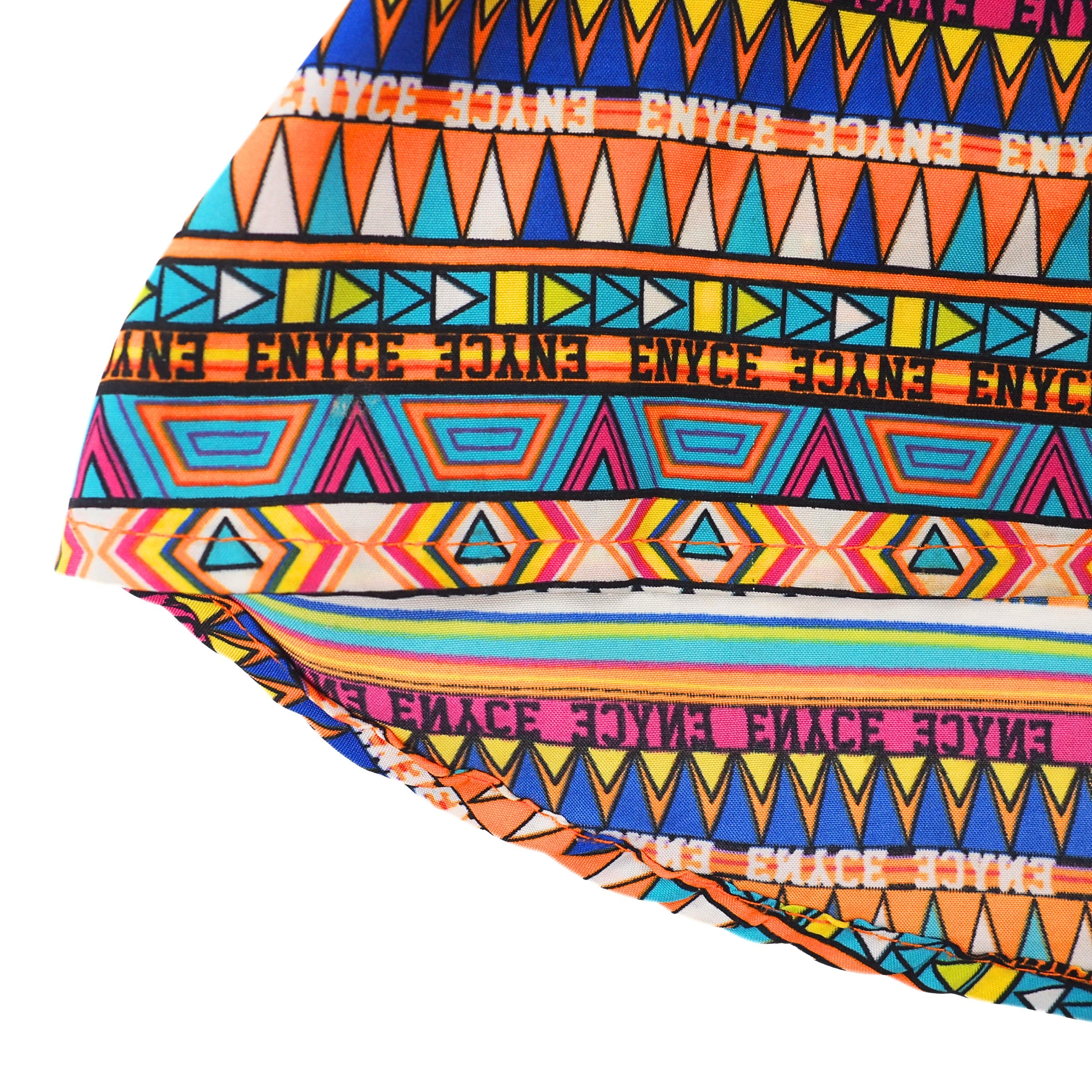 Colorful patterned shirt fabric with 'ENYCE' branding on a white background