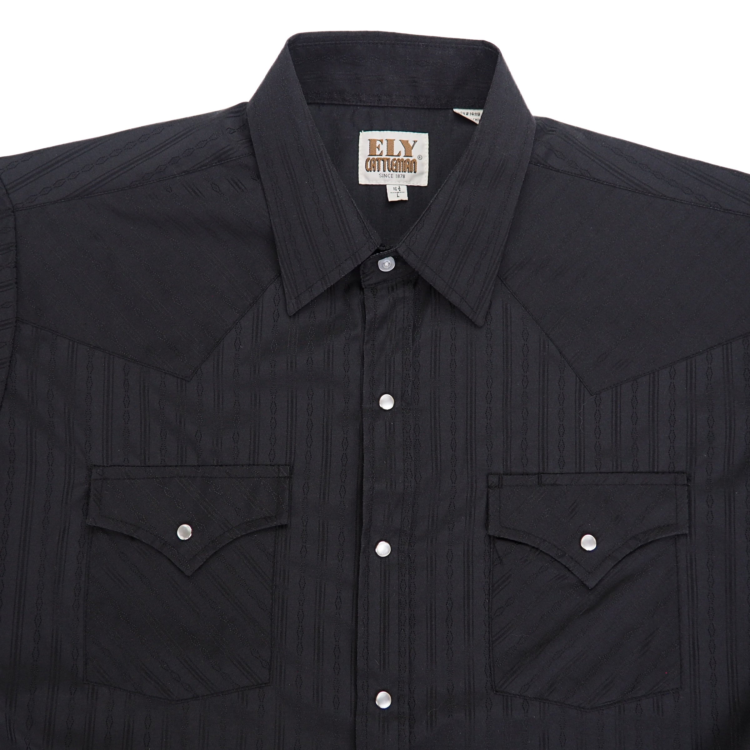 Chest, shoulder and collar area of a black western shirt with pearl snap buttons.