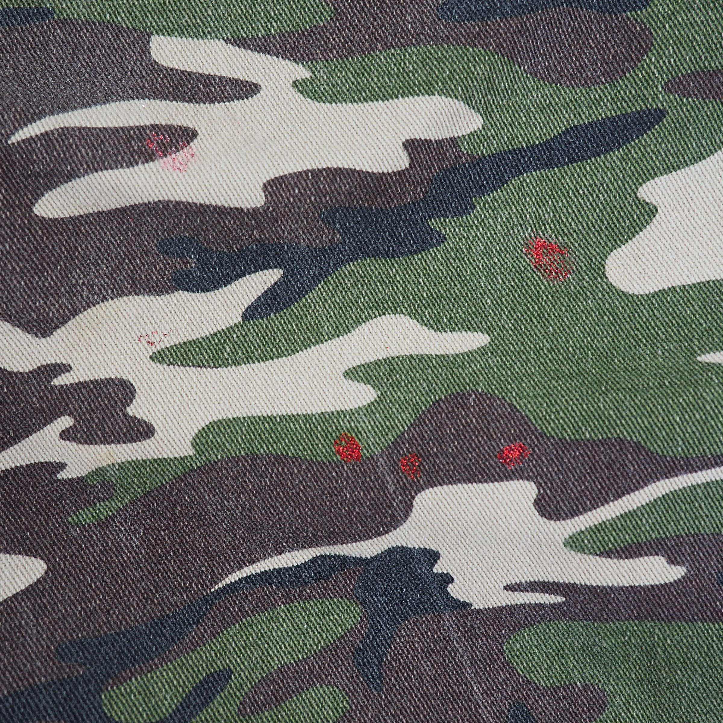 Close-up of camouflage fabric with green, brown, and white pattern