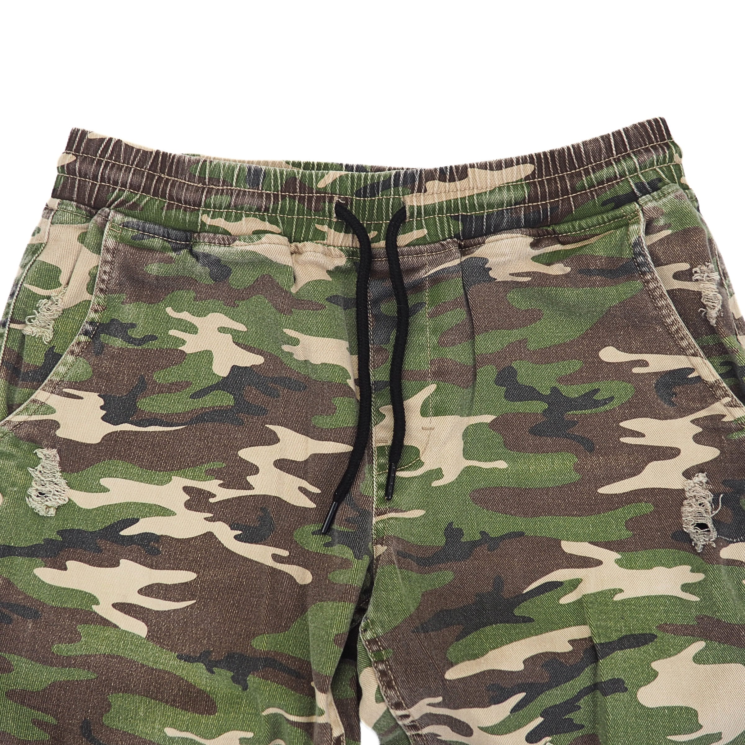 Detail of waist area of a pair of Camouflage pants with a drawstring on a white backgroundea