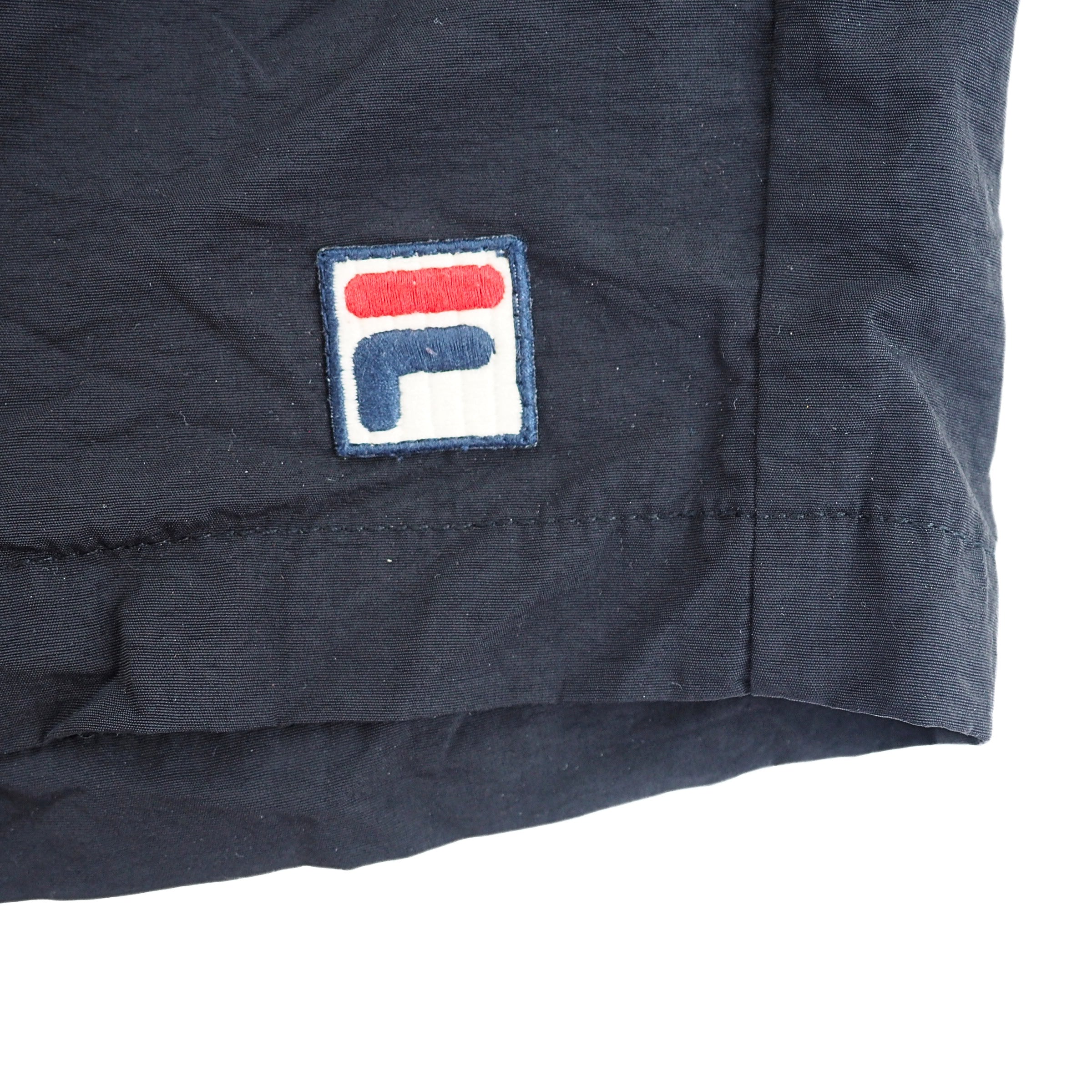 Navy blue fabric with a logo patch on a white background