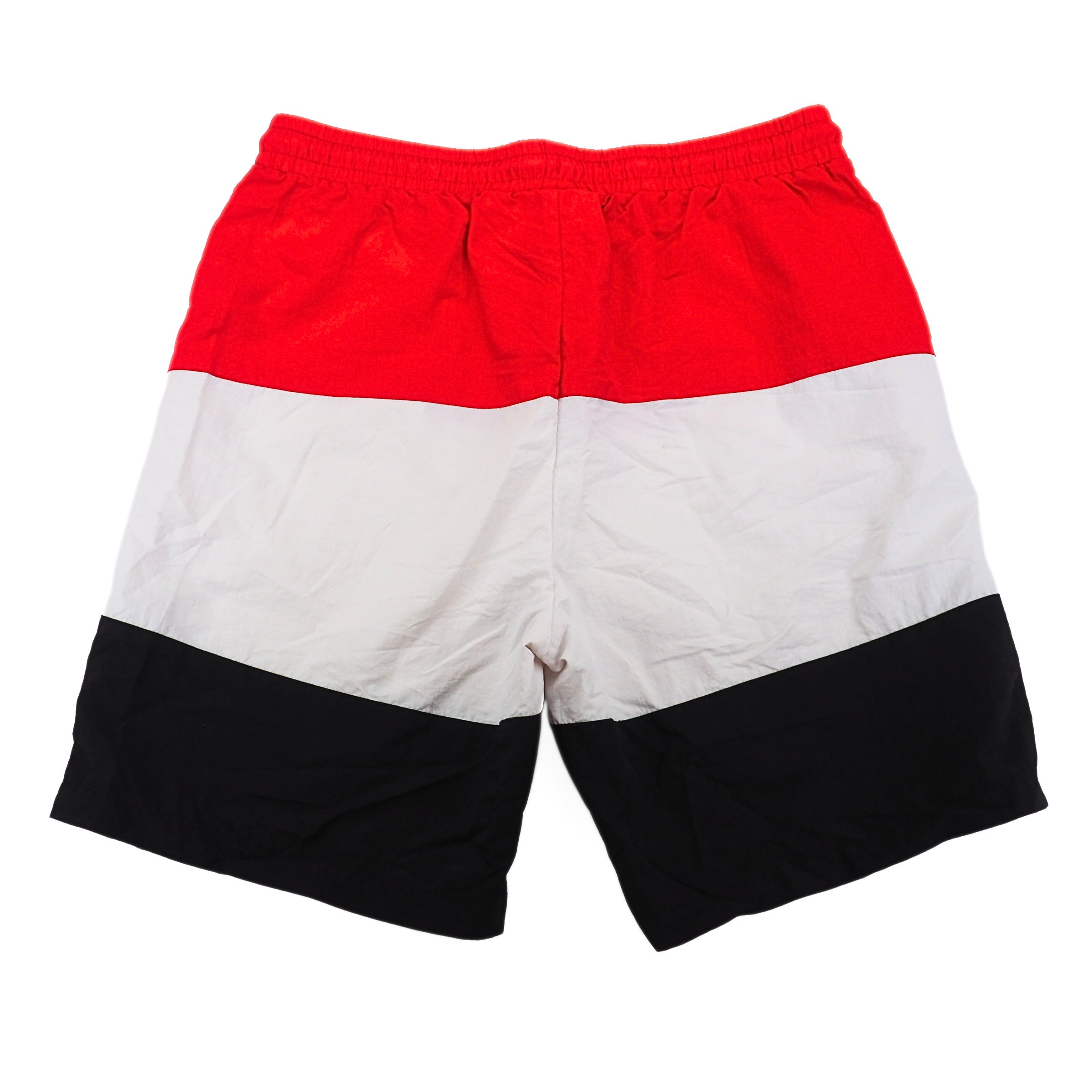 Color-blocked shorts with red, white, and black on a white background