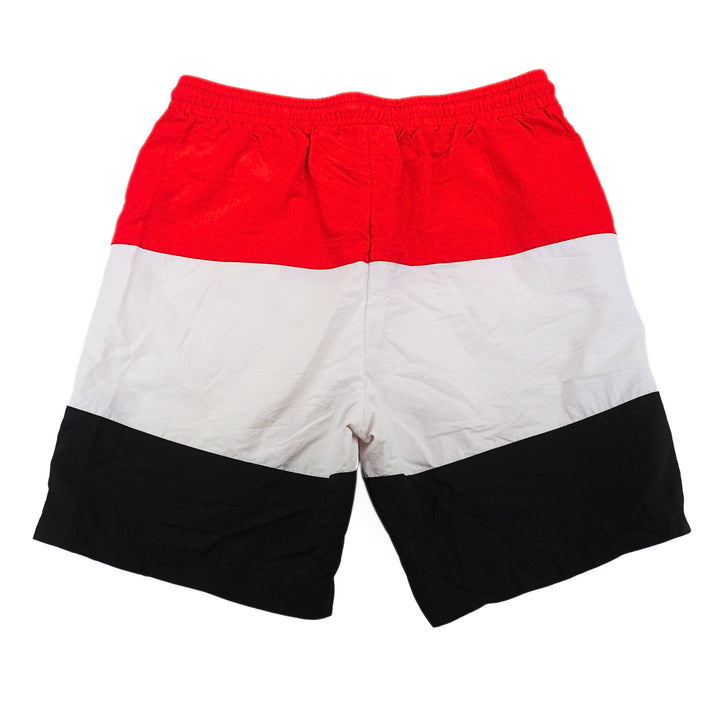 Color-blocked shorts with red, white, and black on a white background