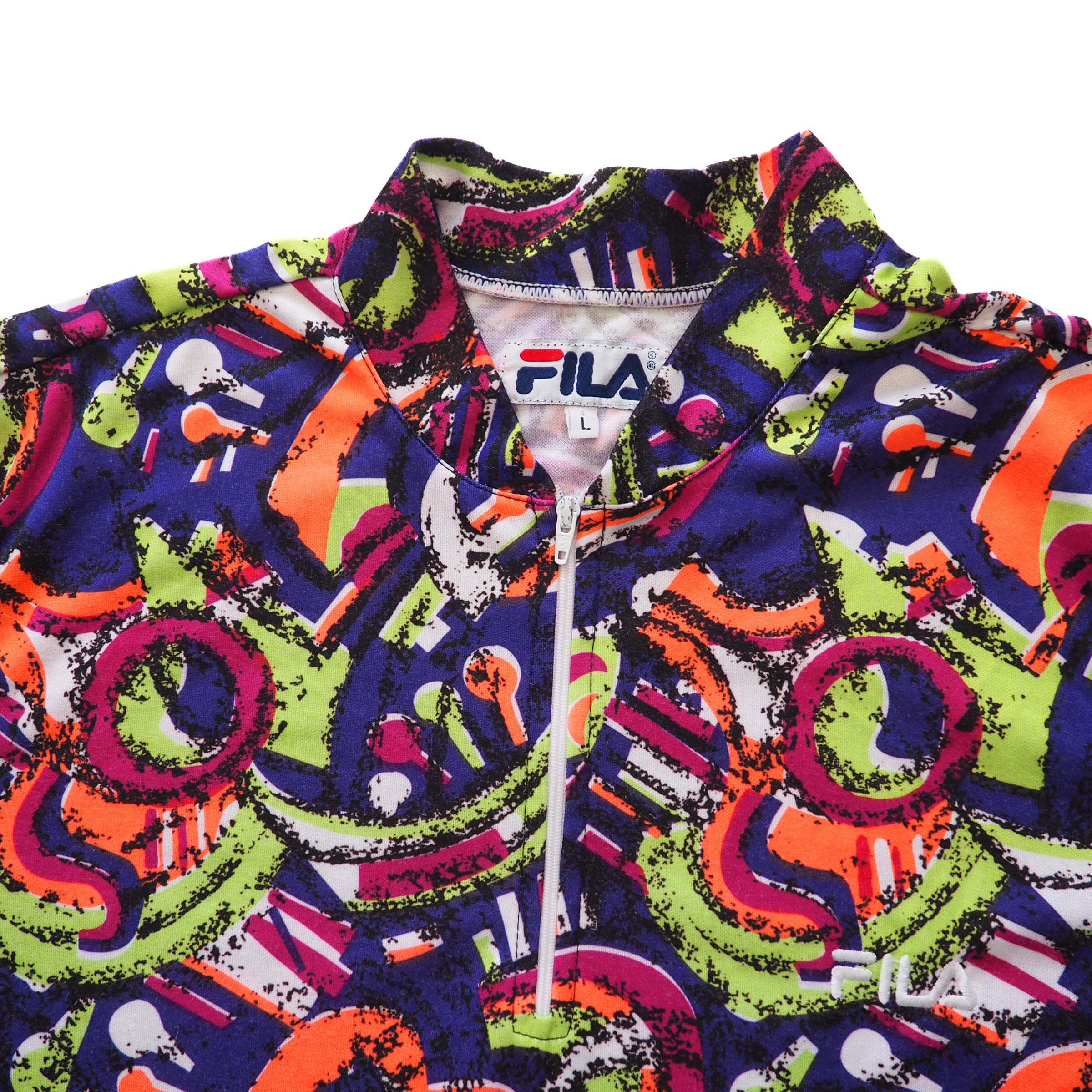 Colorful patterned quarter zip cycling jersey with Fila logo on a white background