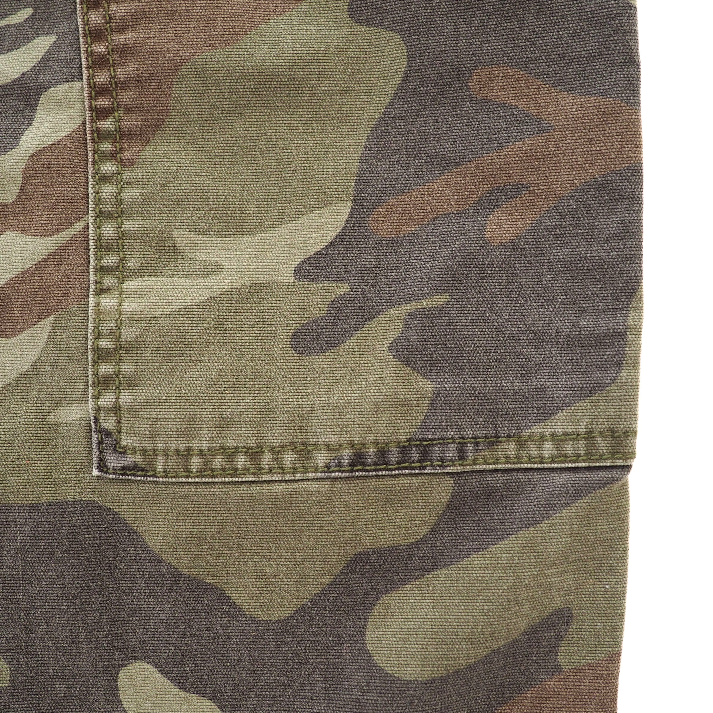 Close up of the eams and stitching details on a pair of camo cargo pants