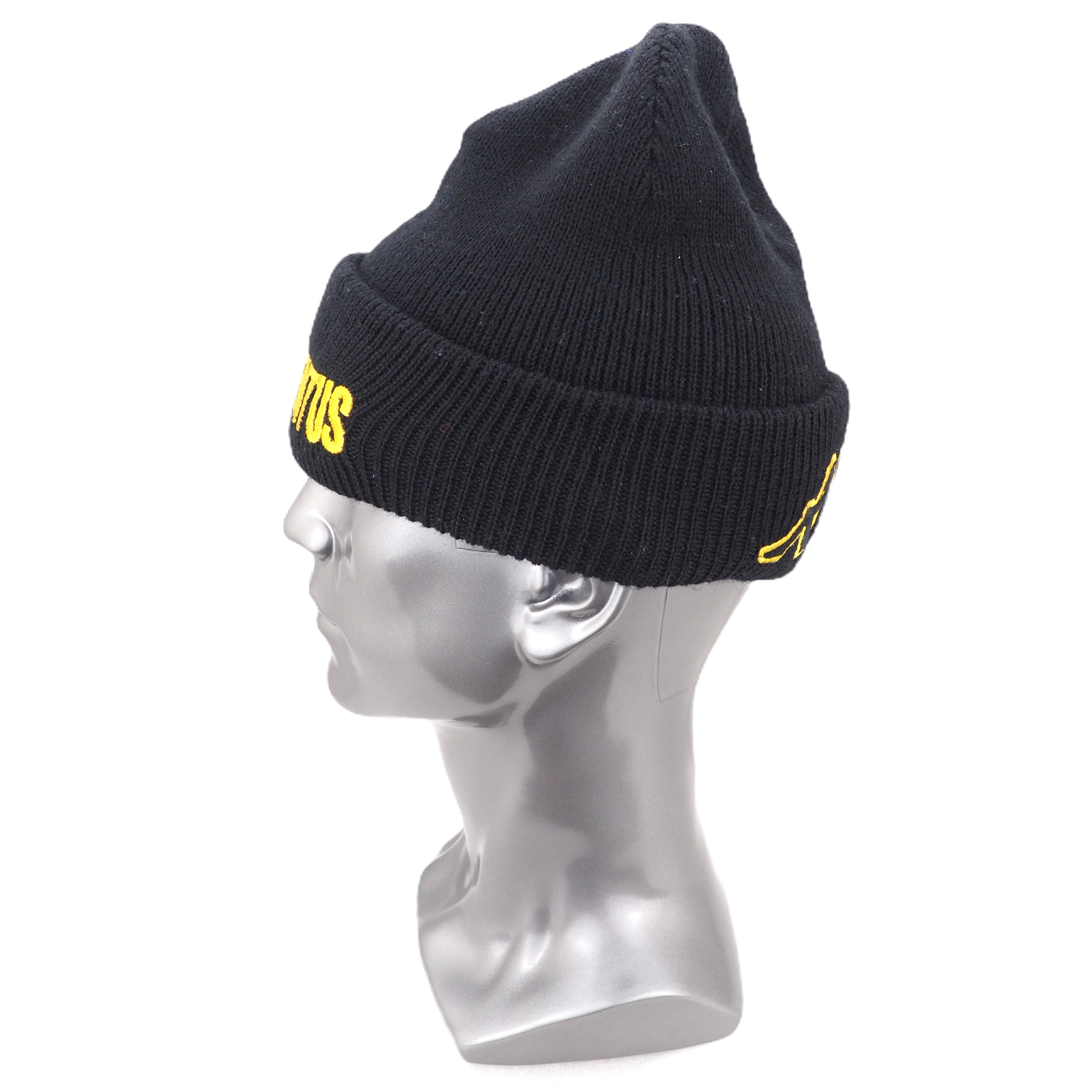 Black beanie with yellow logo on a mannequin head against a white background