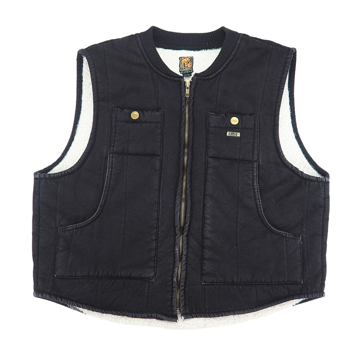 A black quilted denim-style vest with a white sherpa lining, featuring a front zipper, two chest pockets with snap buttons, and two large front patch pockets.
