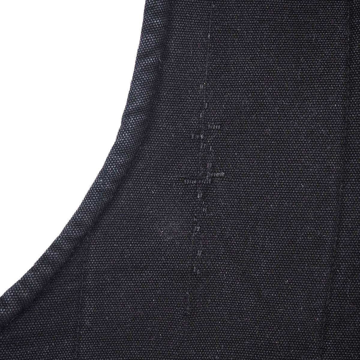 Close-up of a dark charcoal gray woven fabric with a curved seam and visible stitching, set against a plain white background.