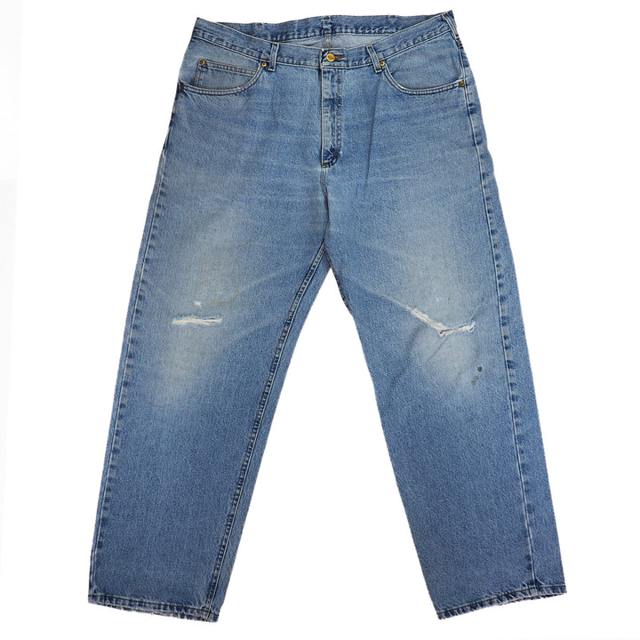 Pair of blue jeans with slight distressing on the knees with a white background