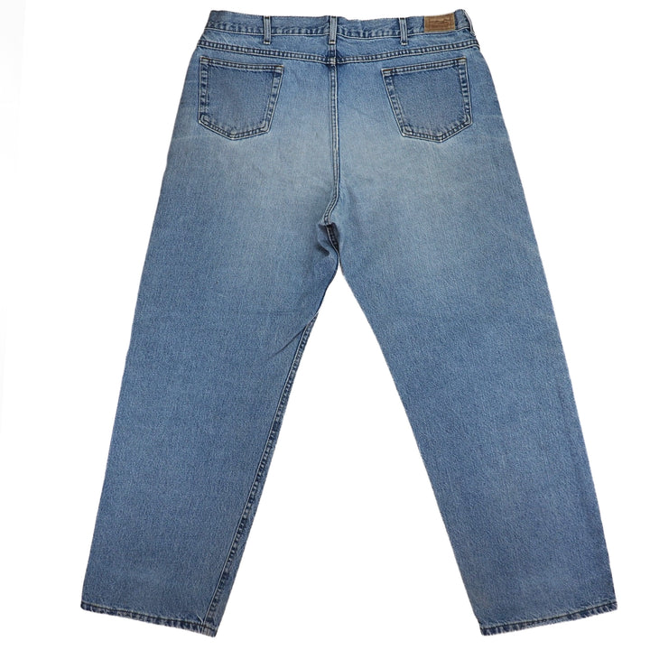 Rear view of a pair of blue denim jeans on a white background