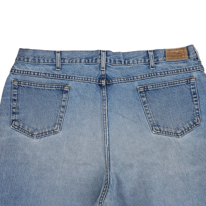 Back view of blue jeans with a visible 'L.L.Bean' leather jarcon patch on a white background