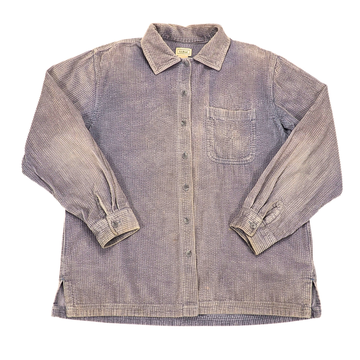 A long-sleeve button-up shirt in a faded purple corduroy fabric, featuring a chest pocket and button-down cuffs, laid flat against a white background.