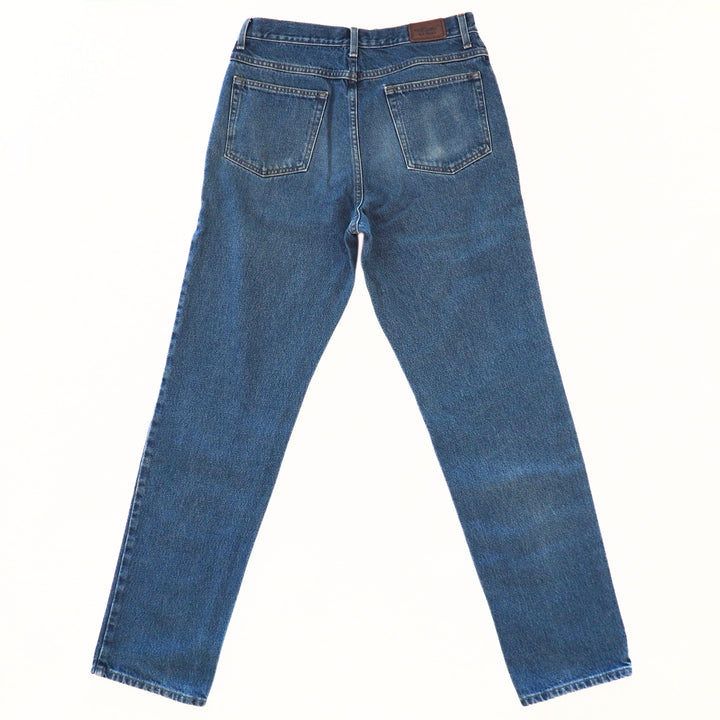 Back view of a pair of blue jeans on a white background